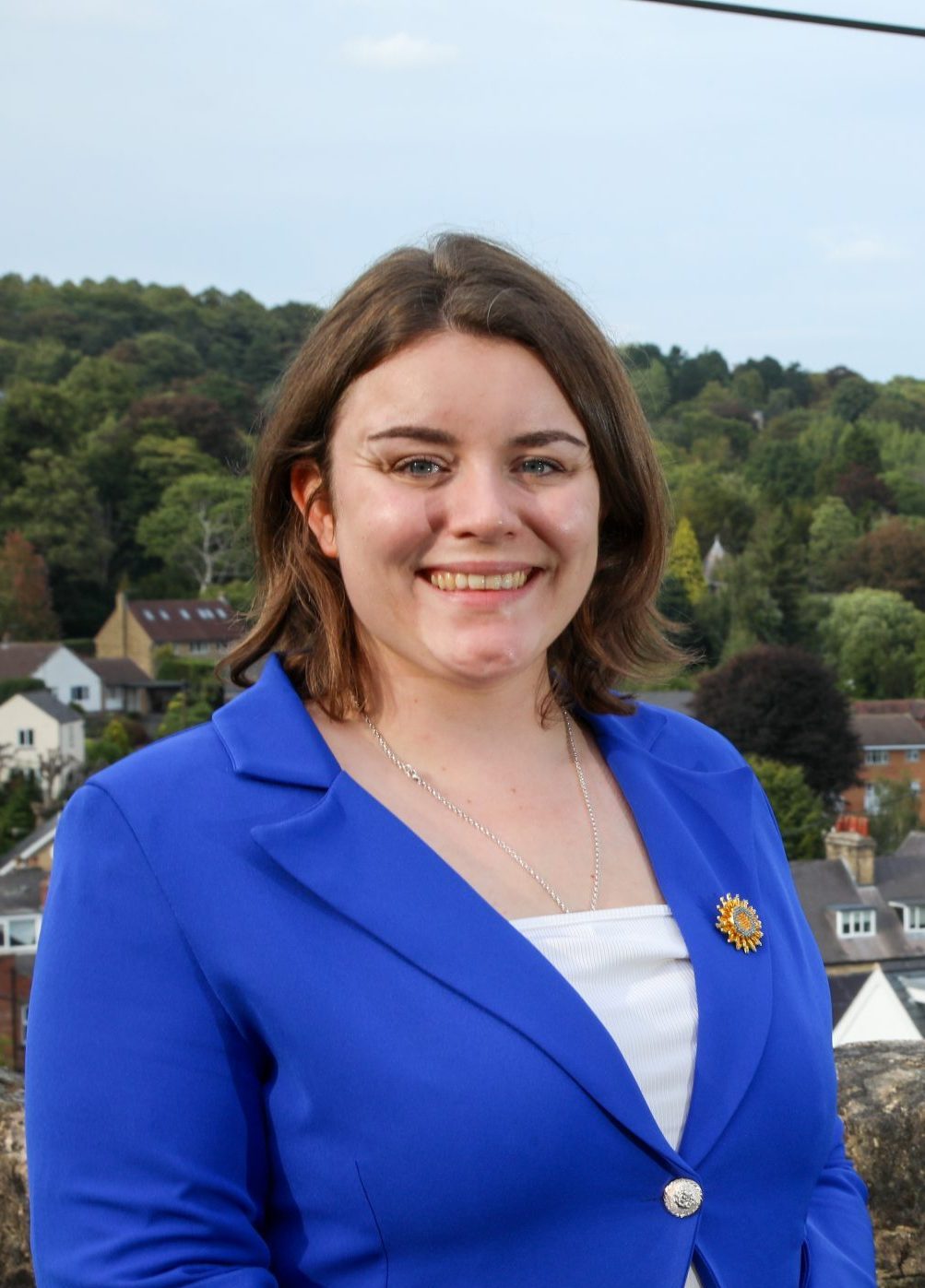 Sophie smiling to camera with a view of Ranmoor behind her.